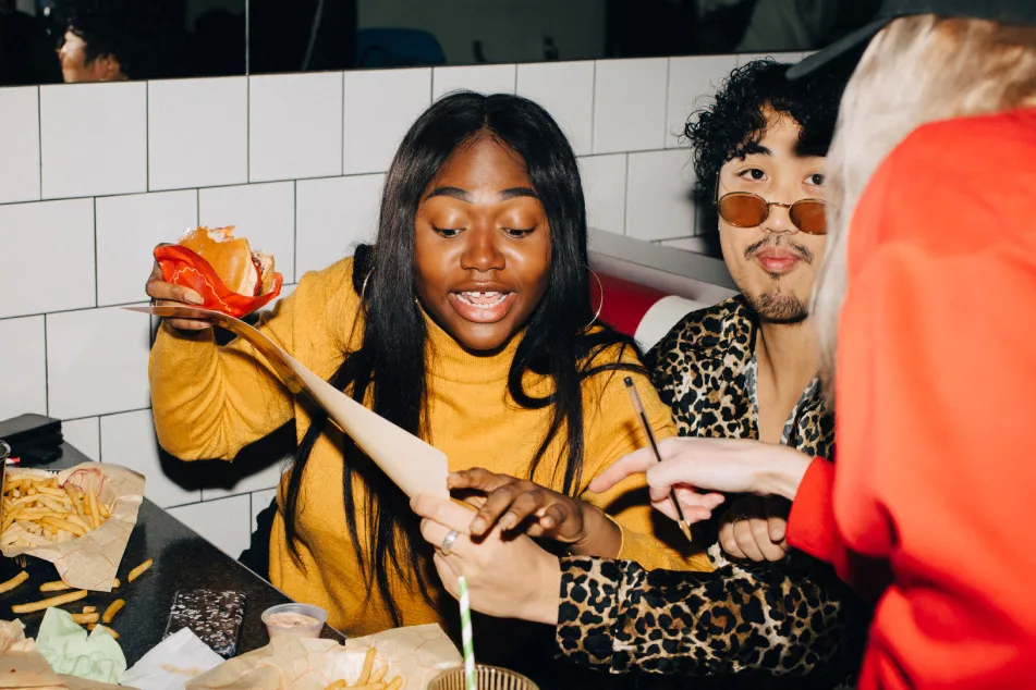 photo of woman with burger ordering food