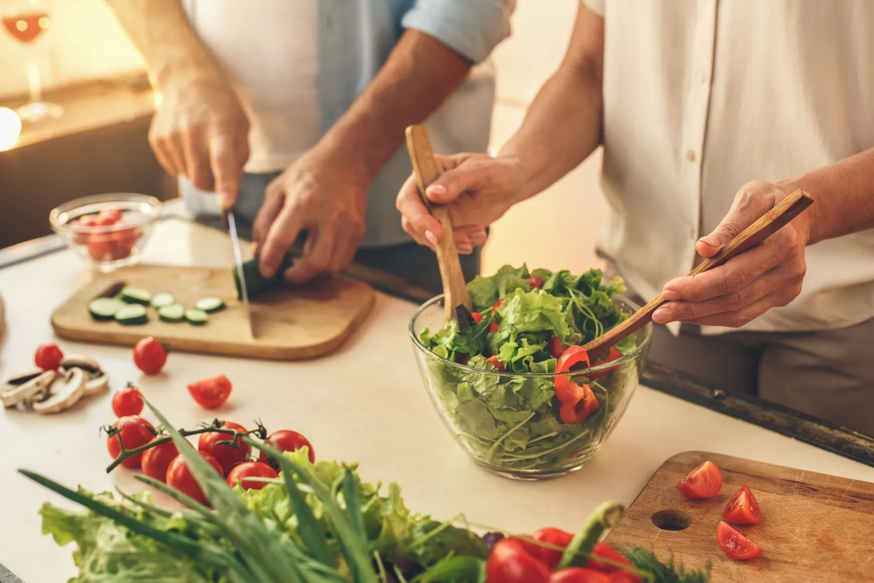 photo of senior couple preparing healthy salad together